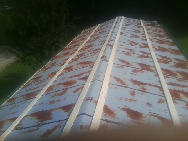 Rusted metal roof panels with new wood purlins before replacement — Storm Damage Roof Repair in Wyandanch by Roofing Brothers
